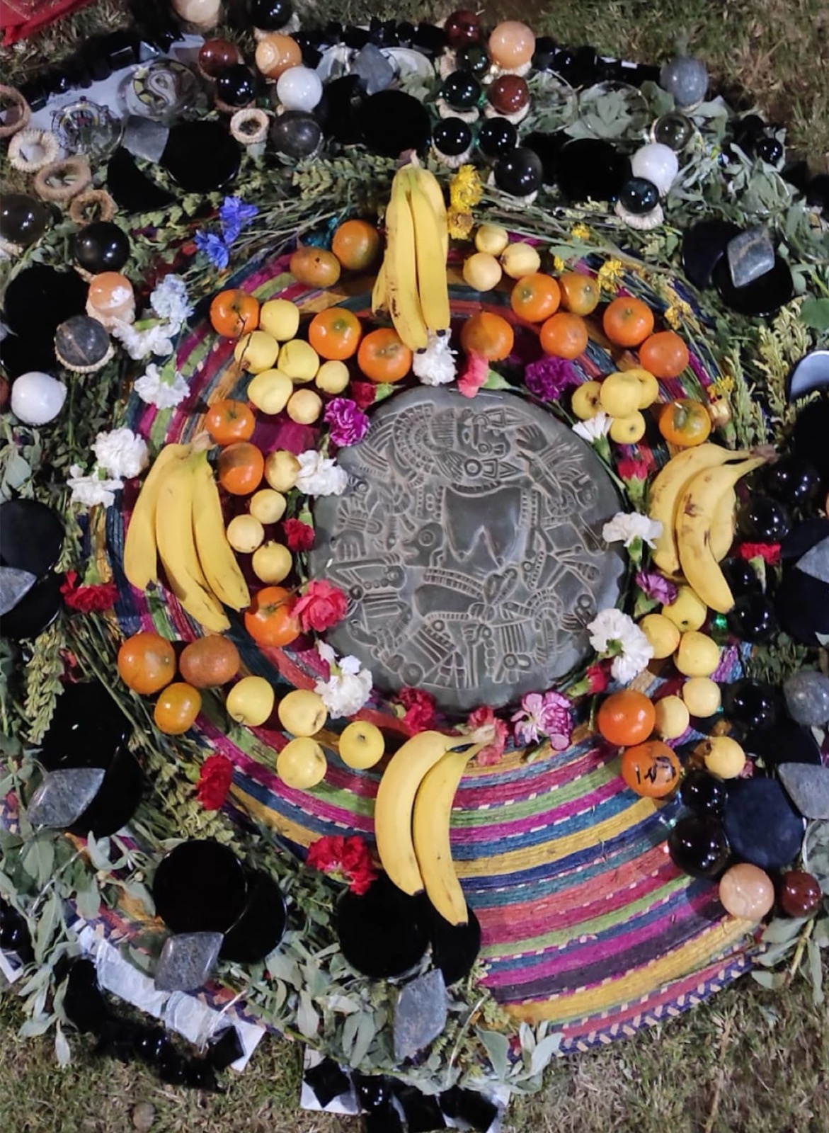 Sacred ceremony altar prepared with fruit, flowers, and stones