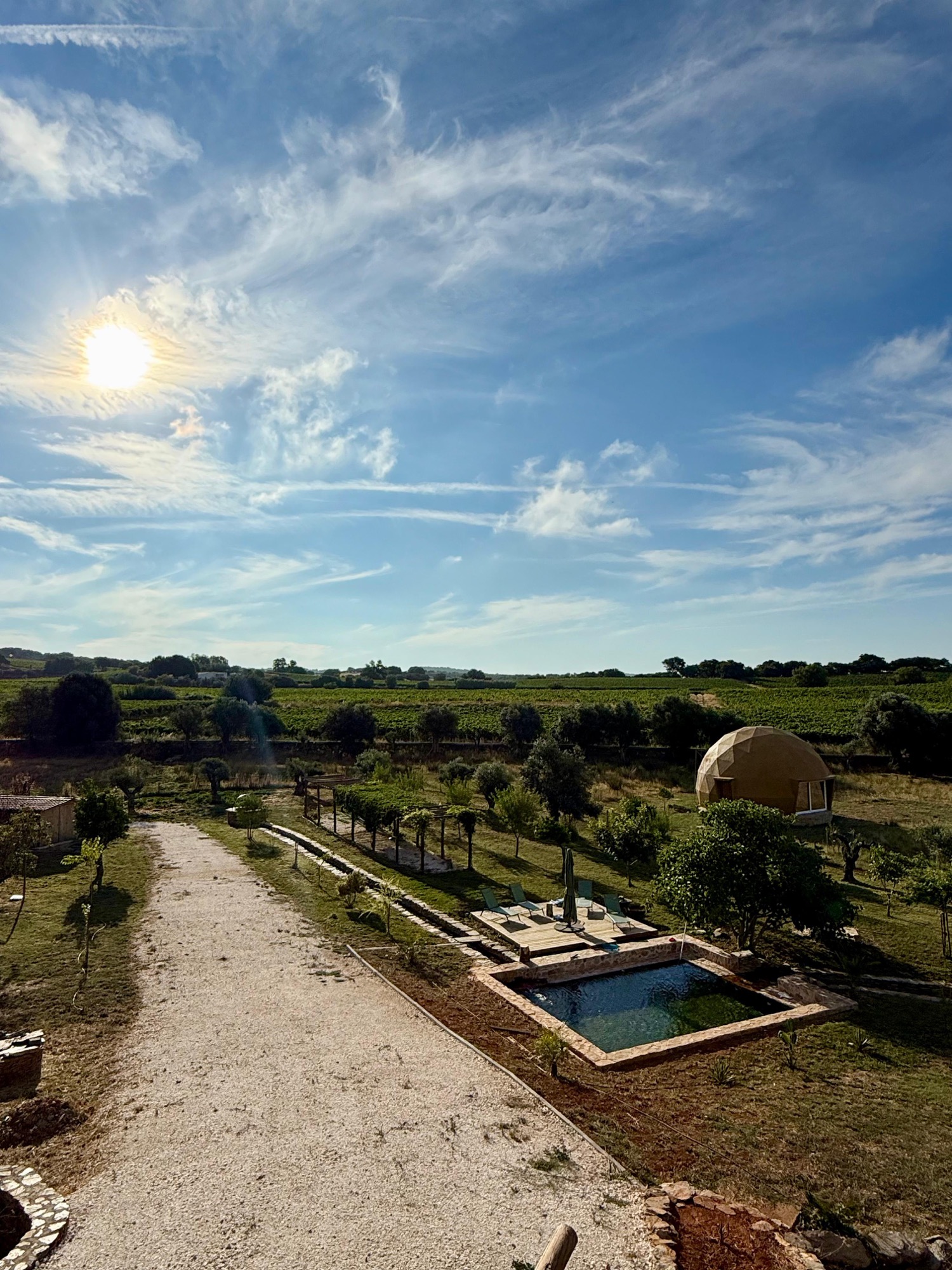 View over the pool, meditation dome and vineyards of the retreat land at sunrise
